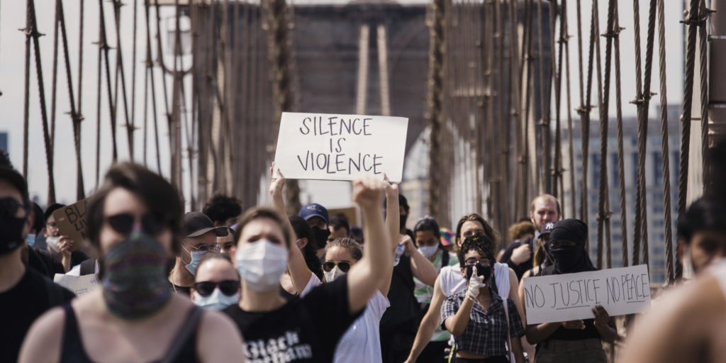 Crowd of protesters holding signs