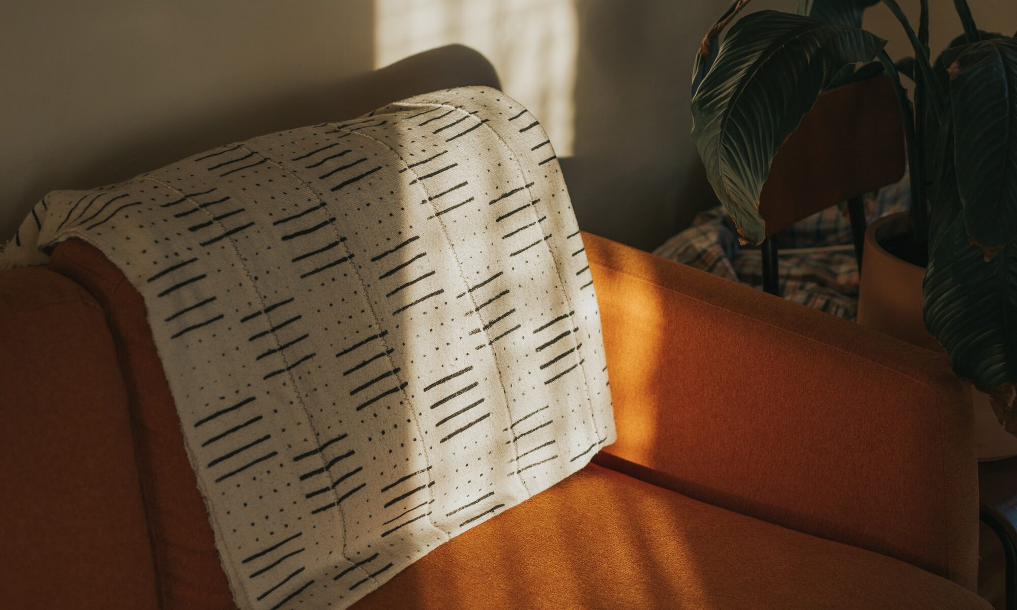white textile on brown couch