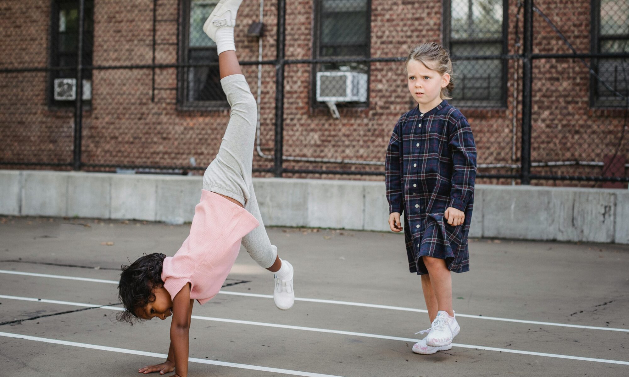 Girl in pink shirt doing cartwheel