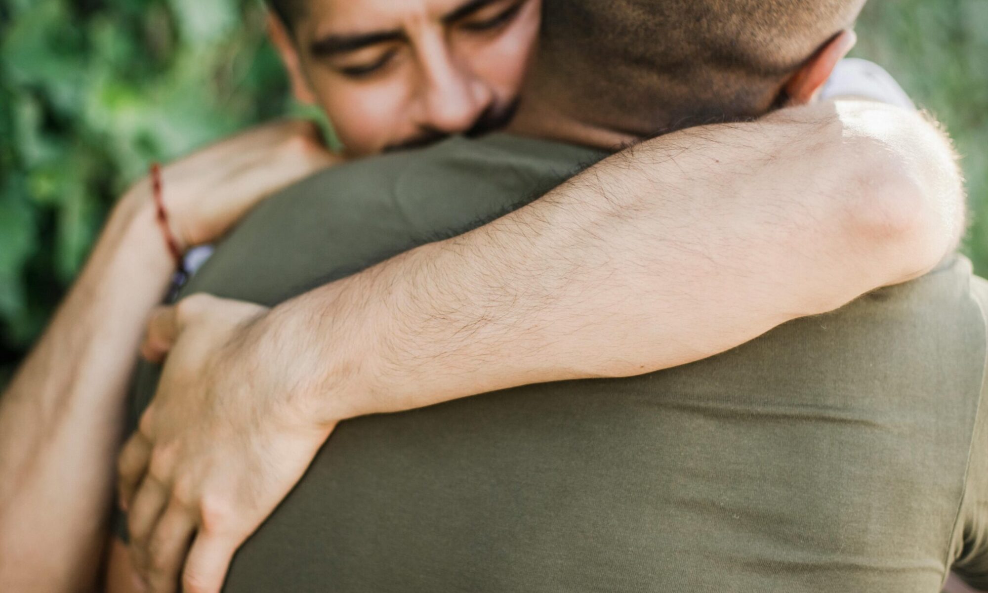 Two men hugging