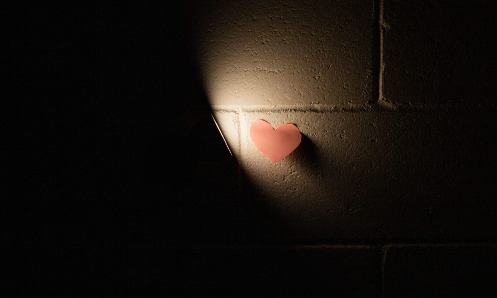 Heart shape sticky note on wall